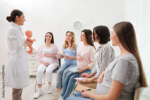 pregnant woman and an instructor in class